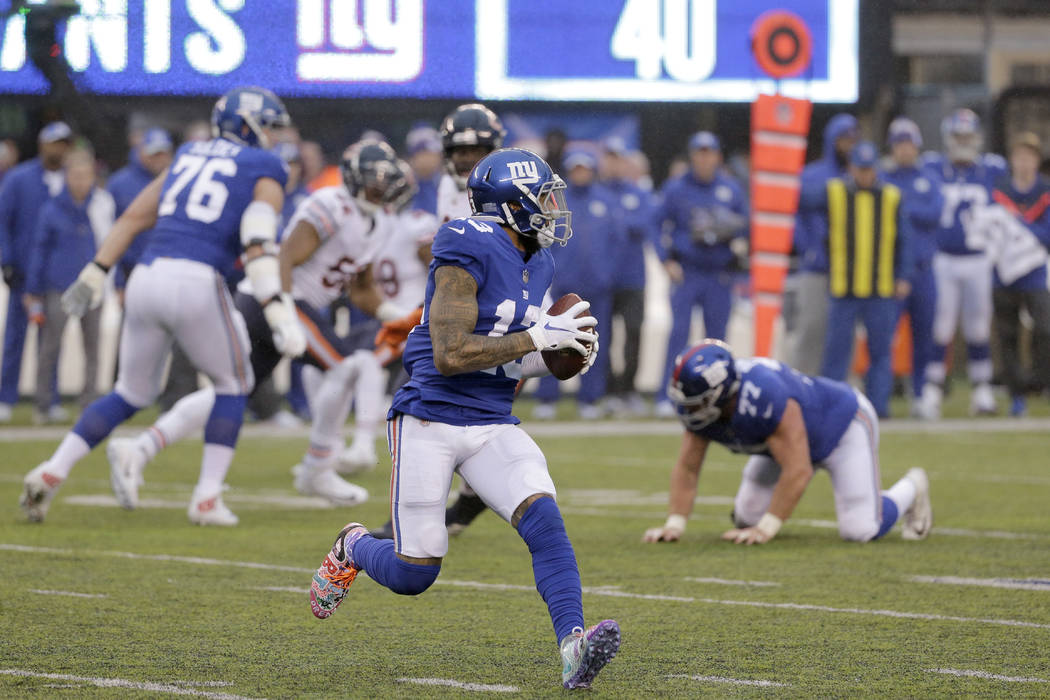 New York Giants wide receiver Odell Beckham prepares to launch a touchdown pass to wide receiver Russell Shepard, not pictured, during the second half of an NFL football game, Sunday, Dec. 2, 2018 ...