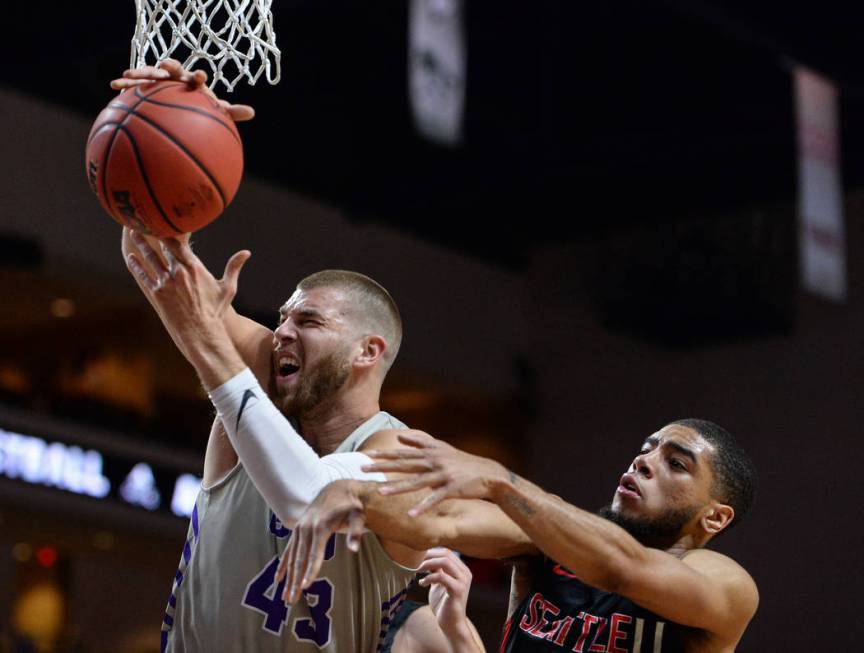 Grand Canyon forward Michael Finke (43) catches a rebound while being guarded by Seattle guard Terrell Brown (23) in the first half of the opening round of the Western Athletic Conference tourname ...