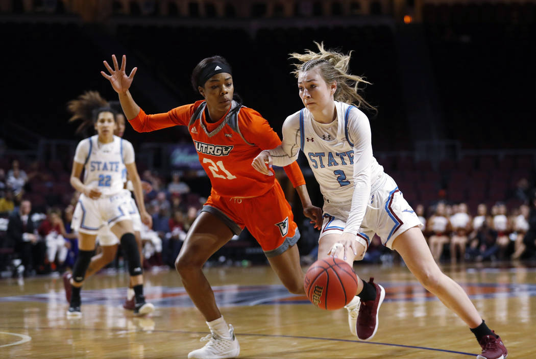 New Mexico State guard Brooke Salas (2) drives past Texas-Rio Grande Valley forward Krisynthia Sampson (21) during a NCAA college basketball Western Athletic Conference Women's Tournament champion ...