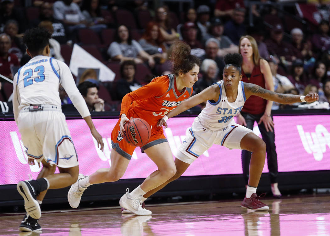 Texas-Rio Grande Valley forward Megan Johnson (34) moves the ball between New Mexico State guard Aaliyah Prince (23) and Gia Pack (30) during a NCAA college basketball Western Athletic Conference ...