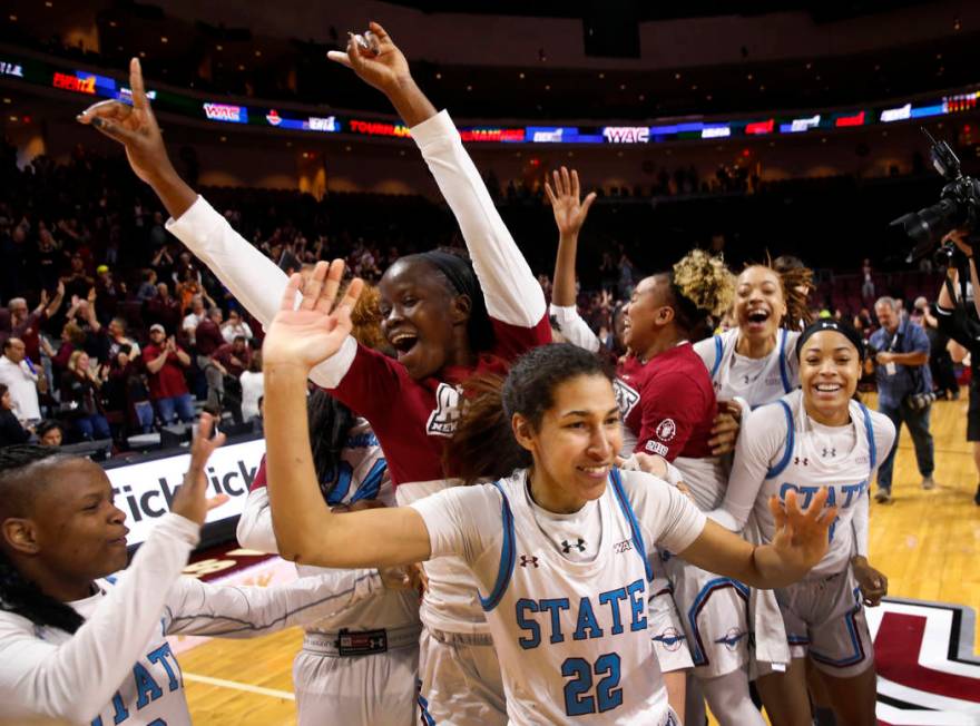 New Mexico State players celebrate after defeating Texas-Rio Grande Valley 76-73 in double overtime during a NCAA college basketball Western Athletic Conference Women's Tournament championship gam ...