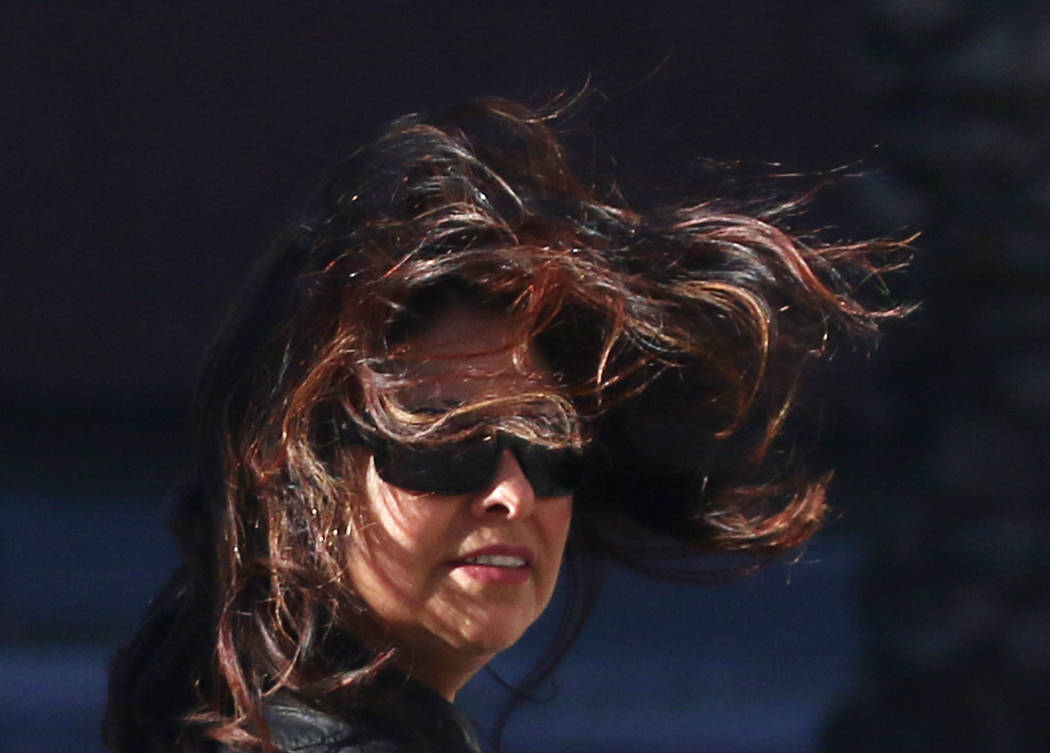 A woman's hair blows across her face as she struggles to walk in strong winds on Casino Center Boulevard on Wednesday, March. 13, 2019, in Las Vegas. Bizuayehu Tesfaye Las Vegas Review-Journal @bi ...