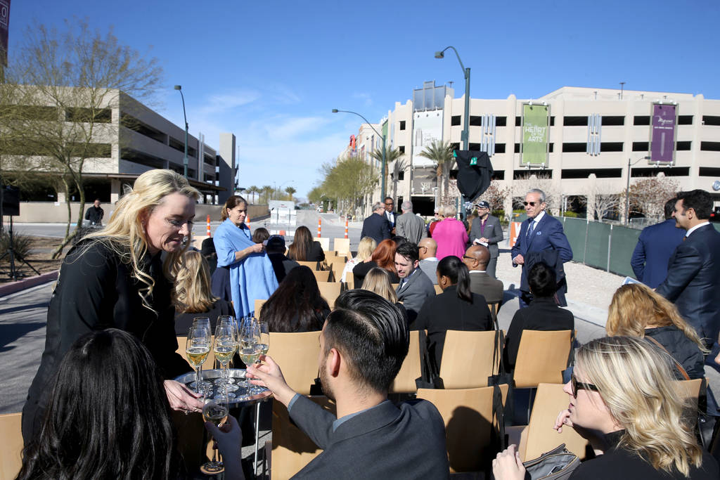 Misty Grimm serves champagne during a unveiling ceremony for Robin Leach Lane running between the Cleveland Clinic Lou Ruvo Center for Brain Health and The Smith Center for the Performing Arts in ...