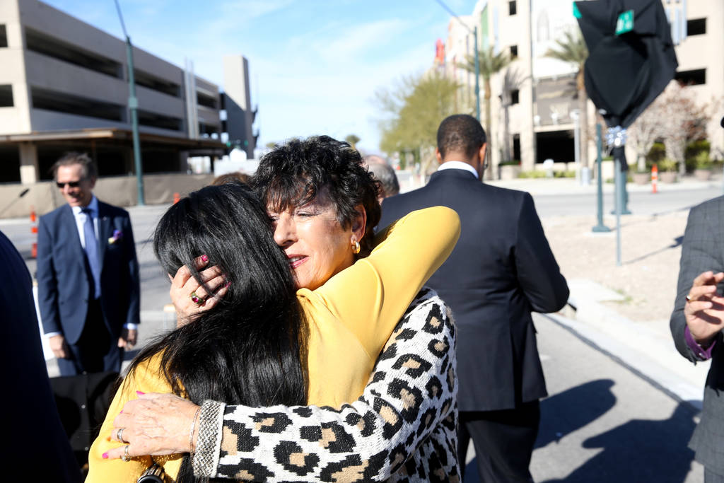 Judy Bryer, right, and Jennifer Romas, both of Las Vegas, hug during a unveiling ceremony for Robin Leach Lane running between the Cleveland Clinic Lou Ruvo Center for Brain Health and The Smith C ...