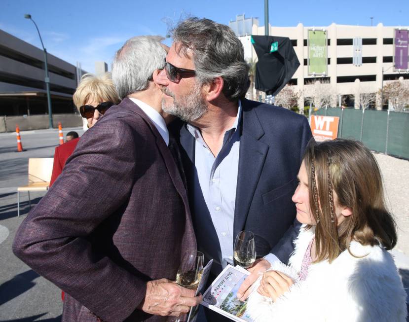 Larry Ruvo, left, visits with the late Robin Leach's son, Steve Leach and his daughter Gianna, 10, during a unveiling ceremony for Robin Leach Lane running between the Cleveland Clinic Lou Ruvo Ce ...