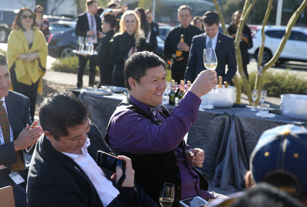 Don Chareunsy, long time friend and colleague of the late Robin Leach, toasts the crowd after they sang happy birthday to him during a unveiling ceremony for Robin Leach Lane running between the C ...