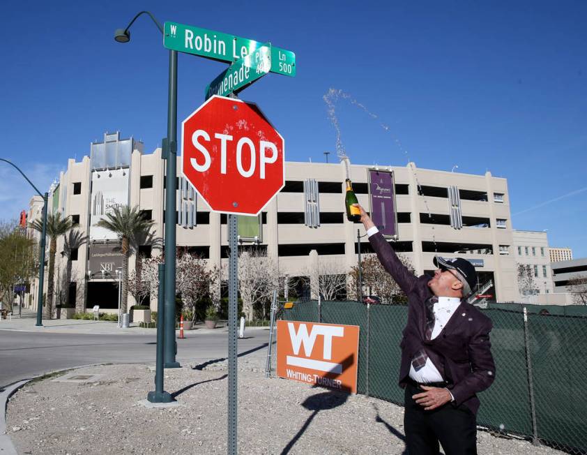 Larry Ruvo uses champagne to christen Robin Leach Lane running between the Cleveland Clinic Lou Ruvo Center for Brain Health and The Smith Center for the Performing Arts in Las Vegas Friday, March ...