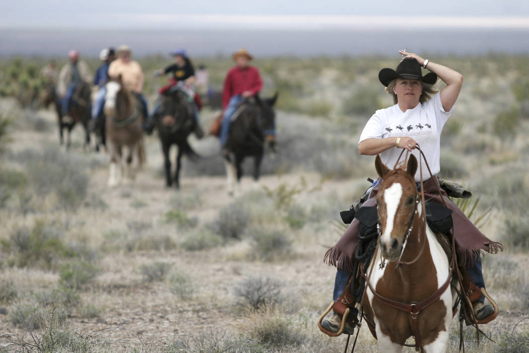 Kelley Bullock, right, rides "Little Gizz" into camp for lunch during the Las Vegas Review-Journal trail ride Friday, April 21, 2006. Some 35 riders along with guides will finish their two-day rid ...