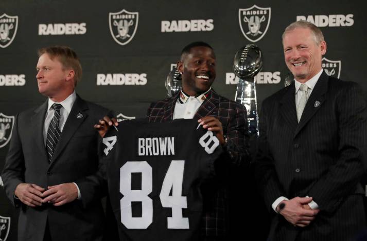 Oakland Raiders wide receiver Antonio Brown, center, holds his son Apollo beside coach Jon Gruden, left, after an NFL news conference Wednesday, March 13, 2019, in Alameda, Calif. (AP Photo/Ben Ma ...