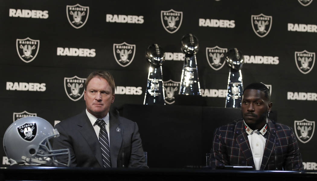 Oakland Raiders coach Jon Gruden, left, and wide receiver Antonio Brown listen to questions from the media during an NFL news conference, Wednesday, March 13, 2019, in Alameda, Calif. (AP Photo/Be ...