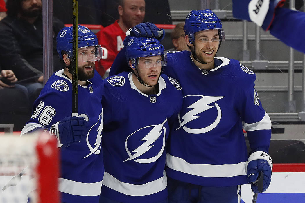 Tampa Bay Lightning center Brayden Point, center, celebrates his goal with Nikita Kucherov (86) and Tampa Bay Lightning defenseman Jan Rutta, right, in the third period of an NHL hockey game again ...