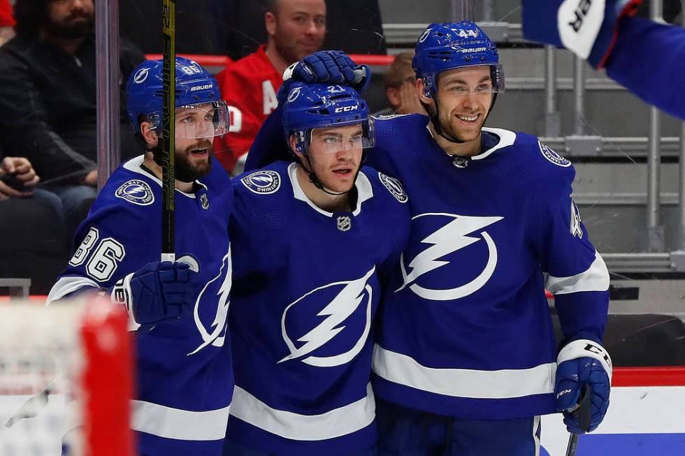 Tampa Bay Lightning center Brayden Point, center, celebrates his goal with Nikita Kucherov (86) and Tampa Bay Lightning defenseman Jan Rutta, right, in the third period of an NHL hockey game again ...