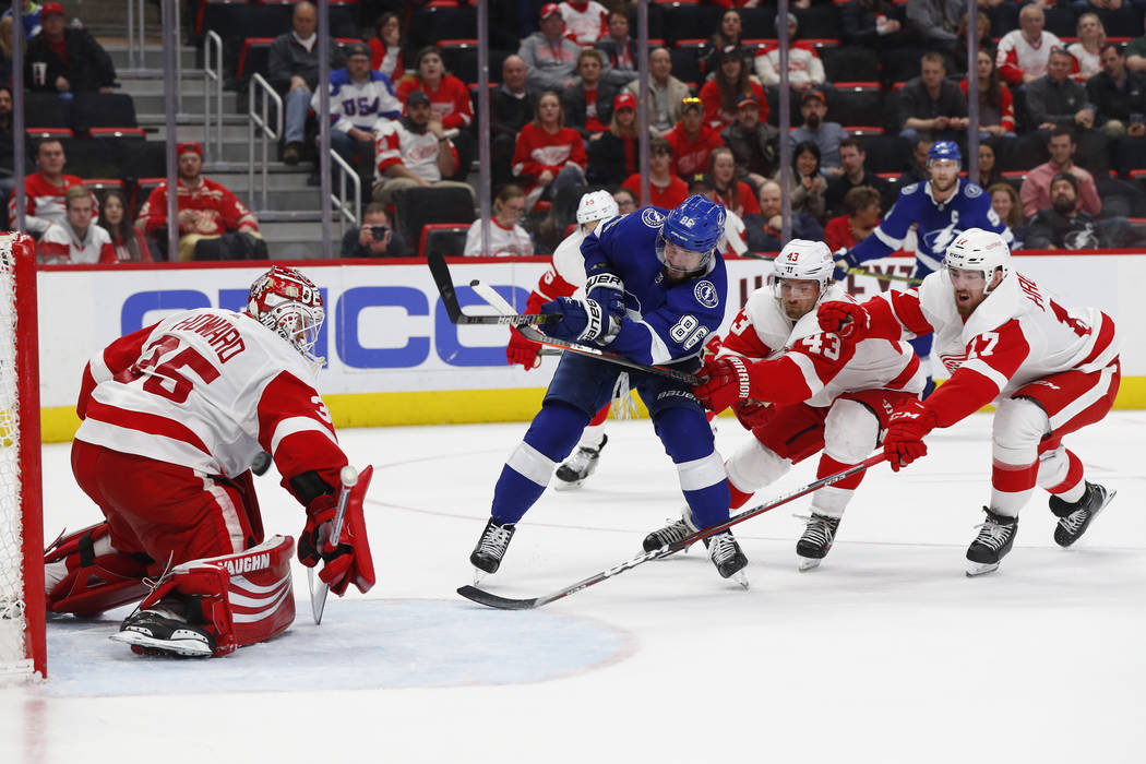 Tampa Bay Lightning's Nikita Kucherov (86) scores a goal on Detroit Red Wings goaltender Jimmy Howard (35) as Darren Helm (43) and Filip Hronek (17) defend in the third period of an NHL hockey gam ...