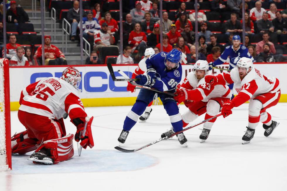 Tampa Bay Lightning's Nikita Kucherov (86) scores a goal on Detroit Red Wings goaltender Jimmy Howard (35) as Darren Helm (43) and Filip Hronek (17) defend in the third period of an NHL hockey gam ...