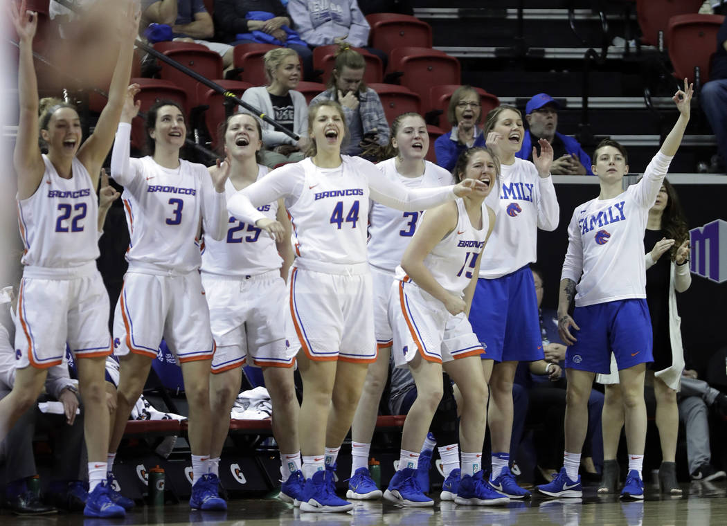 Boise State coach Gordy Presnell cuts the net while celebrating after Boise State defeated Wyoming in an NCAA college basketball game for the Mountain West Conference women's tournament championsh ...