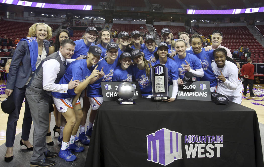 Boise State players pose for photos after defeating Wyoming 68-51 in an NCAA college basketball game for the Mountain West Conference women's tournament championship Wednesday, March 13, 2019, in ...