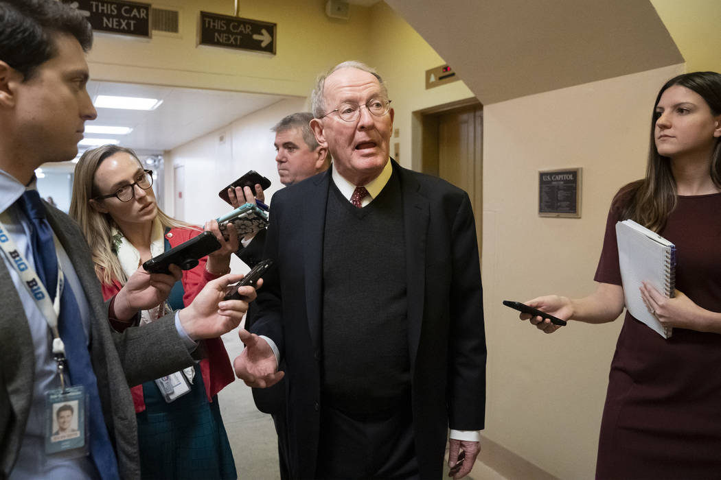 Sen. Lamar Alexander, R-Tenn., tells reporters that he will vote for a resolution to annul President Donald Trump's declaration of a national emergency at the southwest border, on Capitol Hill in ...