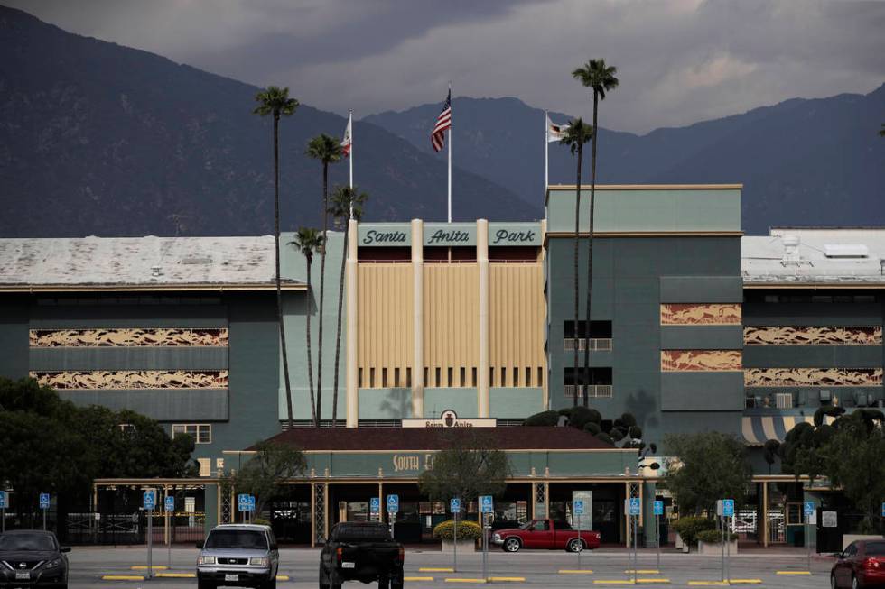 A pickup truck passes an entrance to Santa Anita Park, Tuesday, March 5, 2019, in Arcadia, Calif. A person with direct knowledge of the situation says another horse has died at Santa Anita. The pe ...