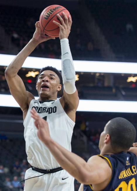 Colorado sophomore guard Tyler Bey (1), a Las Vegas native, drives over California freshman guard Matt Bradley (20) in the second half during the Buffalo's Pac-12 tournament game with the Bears on ...