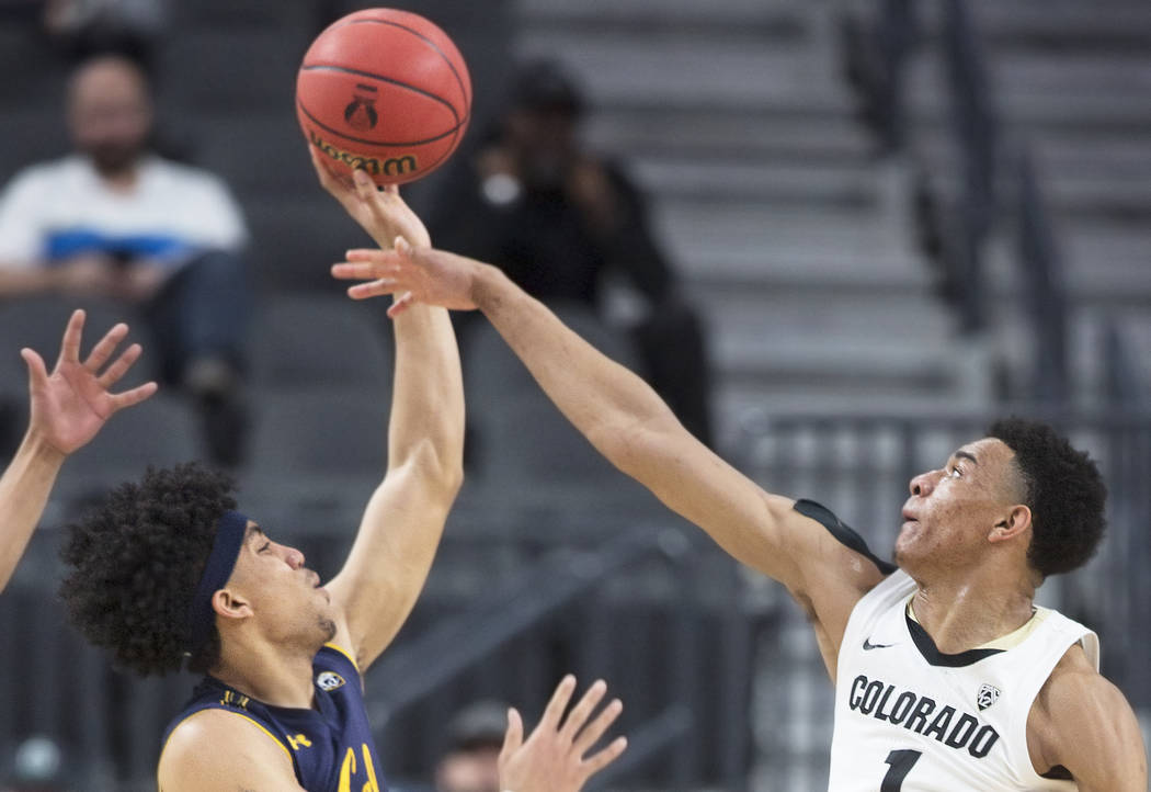 Colorado sophomore guard Tyler Bey (1), a Las Vegas native, blocks the shot of California sophomore forward Justice Sueing in the first half during the Buffalo's Pac-12 tournament game with the Be ...