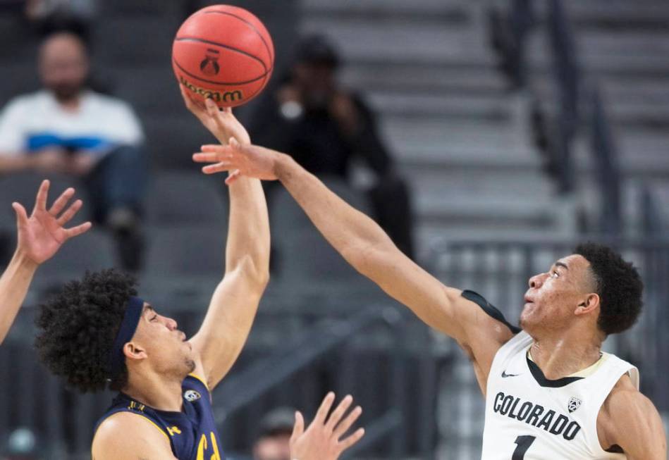 Colorado sophomore guard Tyler Bey (1), a Las Vegas native, blocks the shot of California sophomore forward Justice Sueing in the first half during the Buffalo's Pac-12 tournament game with the Be ...