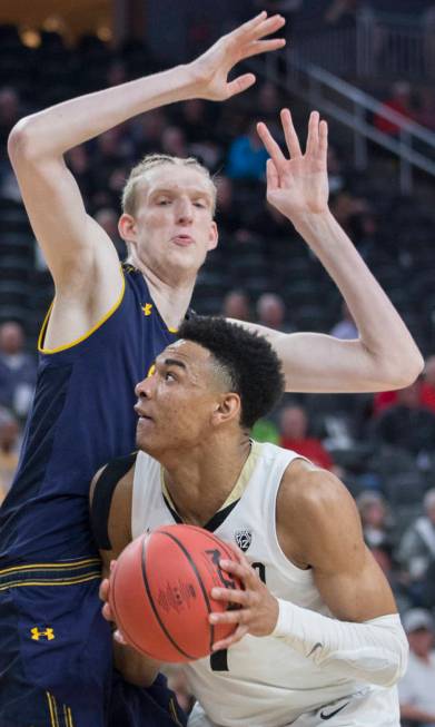 Colorado sophomore guard Tyler Bey (1), a Las Vegas native, fights for position with California freshman center Connor Vanover (23) in the second half during the Pac-12 tournament on Wednesday, Ma ...