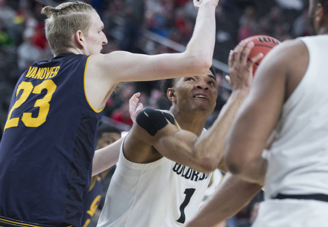 Colorado sophomore guard (1), a Las Vegas native, drives past California freshman center Connor Vanover (23) in the second half during the Pac-12 tournament on Wednesday, March 13, 2019, at T-Mobi ...
