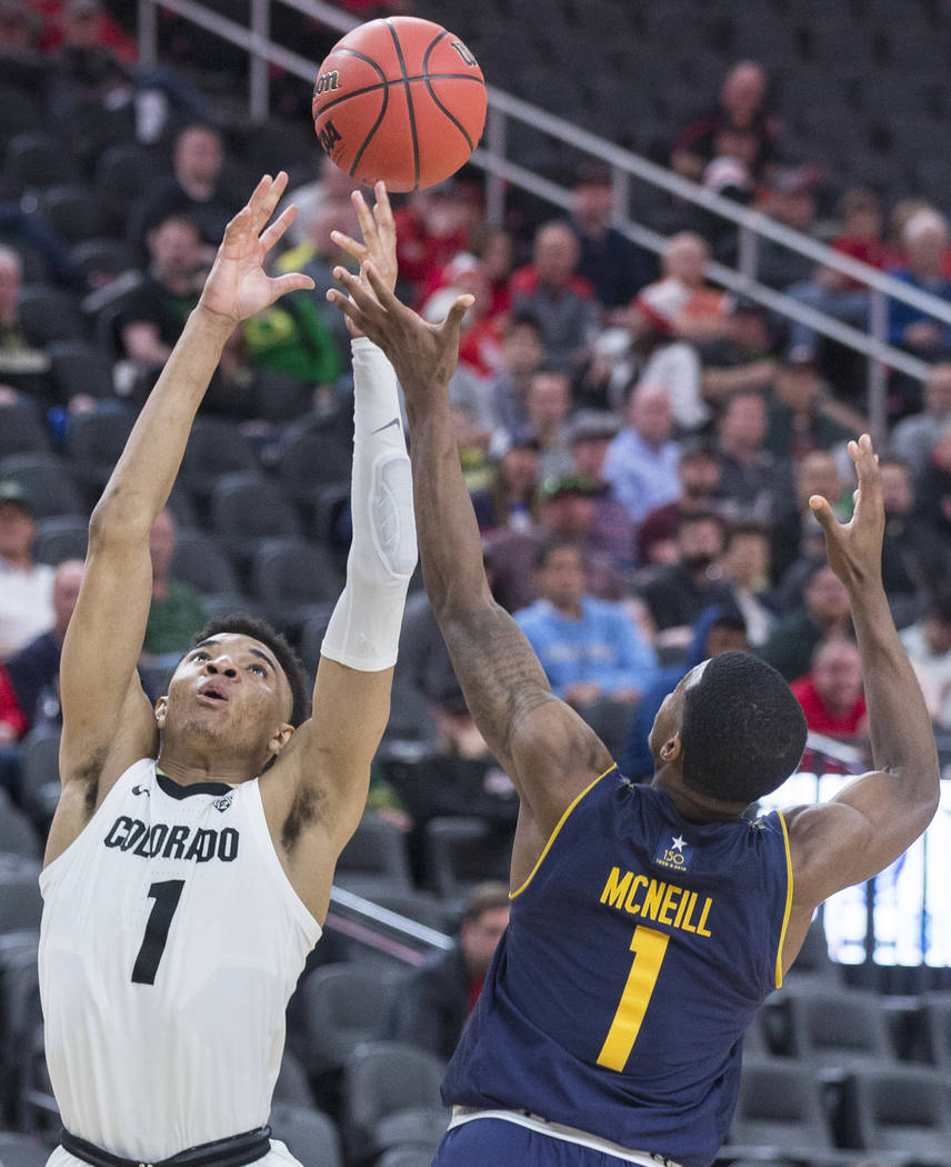 Colorado sophomore guard Tyler Bey (1), a Las Vegas native, fights for a rebound with California sophomore guard Darius McNeill (1) in the second half during the Pac-12 tournament on Wednesday, Ma ...