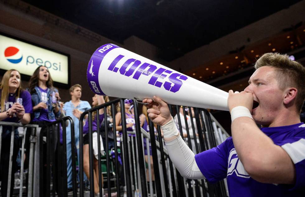 Grand Canyon University student Grayson Higgins cheers to the student section as they cheer on their team in the second half of the opening round of the Western Athletic Conference tournament agai ...