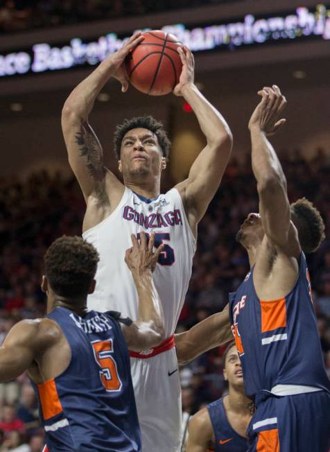 Gonzaga junior forward Brandon Clarke (15) grabs a rebound over Pepperdine sophomore guard Jade' Smith (5) in the first half during the West Coast Conference semifinal game on Monday, March 11, 20 ...