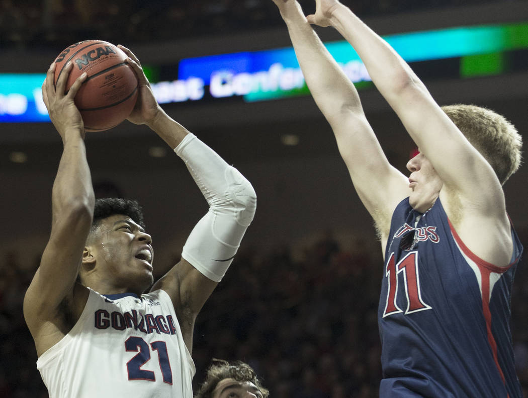 Gonzaga junior forward Rui Hachimura (21) drives over Saint Mary's freshman forward Matthias Tass (11) in the first half during the West Coast Conference finals game on Tuesday, March 12, 2019, at ...