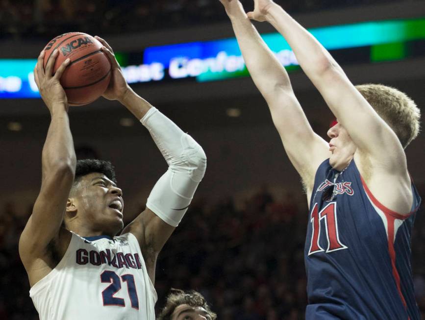 Gonzaga junior forward Rui Hachimura (21) drives over Saint Mary's freshman forward Matthias Tass (11) in the first half during the West Coast Conference finals game on Tuesday, March 12, 2019, at ...