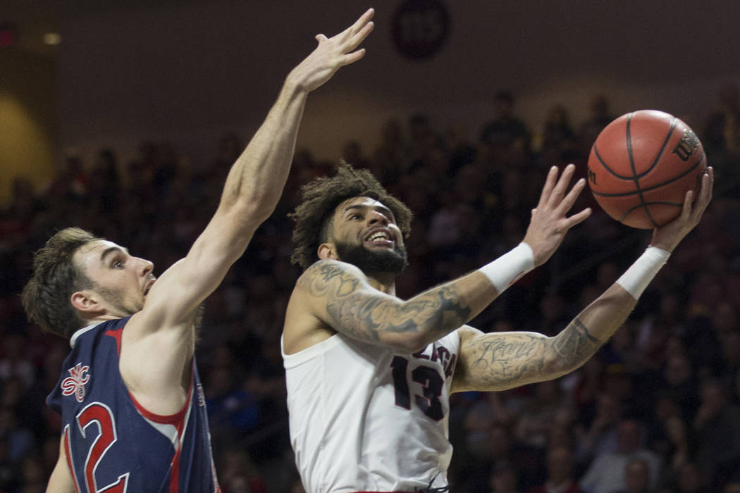 Gonzaga senior guard Josh Perkins (13) slices to the rim past Saint Mary's sophomore guard Tommy Kuhse (12) in the first half during the West Coast Conference finals game on Tuesday, March 12 ...