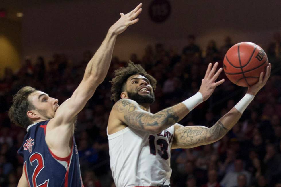 Gonzaga senior guard Josh Perkins (13) slices to the rim past Saint Mary's sophomore guard Tommy Kuhse (12) in the first half during the West Coast Conference finals game on Tuesday, March 12 ...