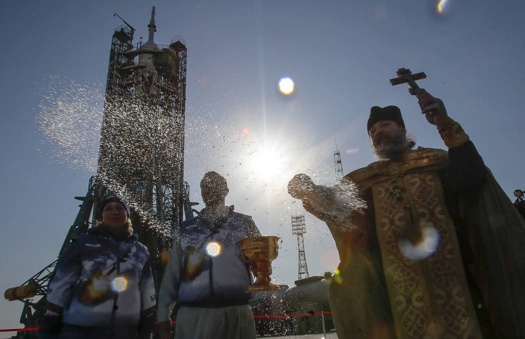 An Orthodox priest conducts a blessing service in front of the Soyuz FG rocket at the Russian leased Baikonur cosmodrome, Kazakhstan, Thursday, March 14, 2019. The new Soyuz mission to the Interna ...