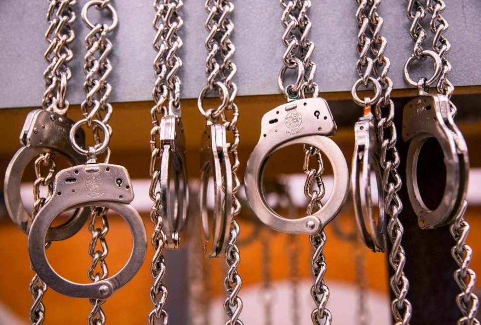 A row of handcuffs hang at the Metro Traffic Bureau during a Metro "DUI blitz" event on Thursday, March 14, 2019, in Las Vegas. (Benjamin Hager Review-Journal) @BenjaminHphoto