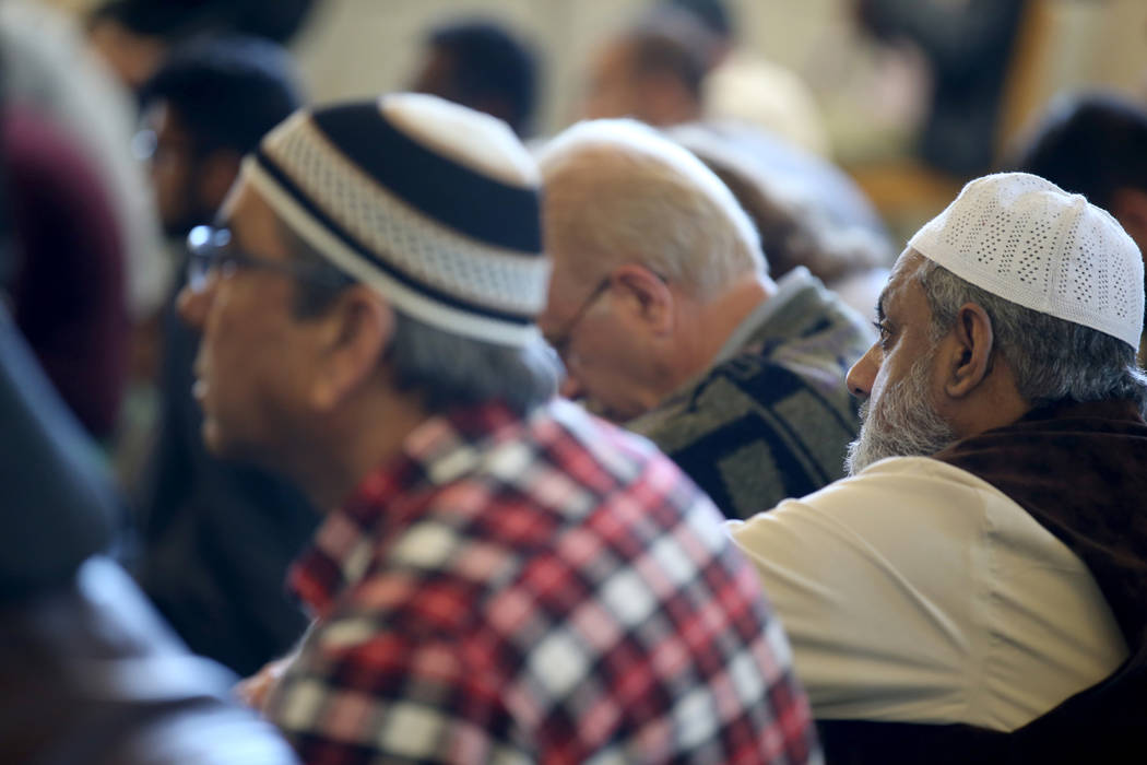 Worshipers, including Dr. Mohammad Hassan, right, listen to Shaykh Obair Katchi, Imam of Corona Masjid in California, during a prayer service at the Mosque of Islamic Society of Nevada in Las Vega ...