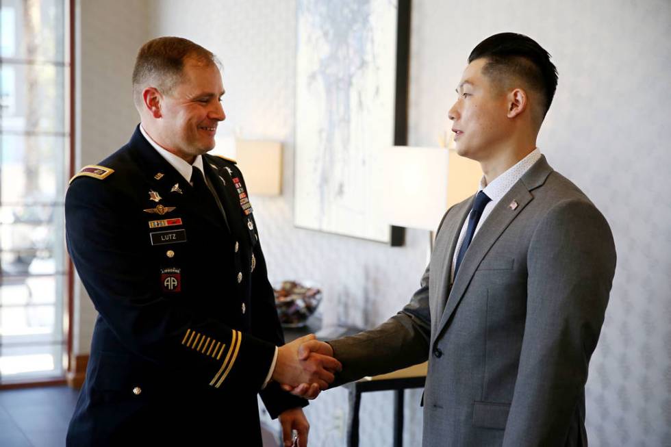 U.S. Army battalion commander Ken Lutz of the 6th Medical Recruiting Battalion, left, congratulates Anthony Hua after getting sworn in as captain for the U.S. Army Reserve during a ceremony at the ...