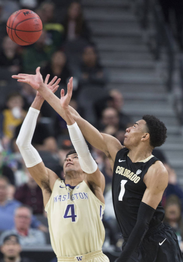 Colorado sophomore guard Tyler Bey (1) fights for a loose ball with Washington senior guard Matisse Thybulle (4) in the second half during the semifinal game of the Pac-12 tournament on Friday, Ma ...