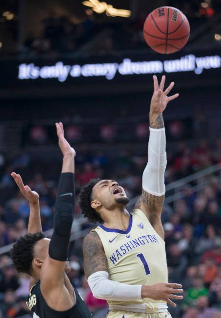 Washington senior guard David Crisp (1) slices to the rim past Colorado junior guard Shane Gatling (0) in the second half during the semifinal game of the Pac-12 tournament on Friday, March 15, 20 ...
