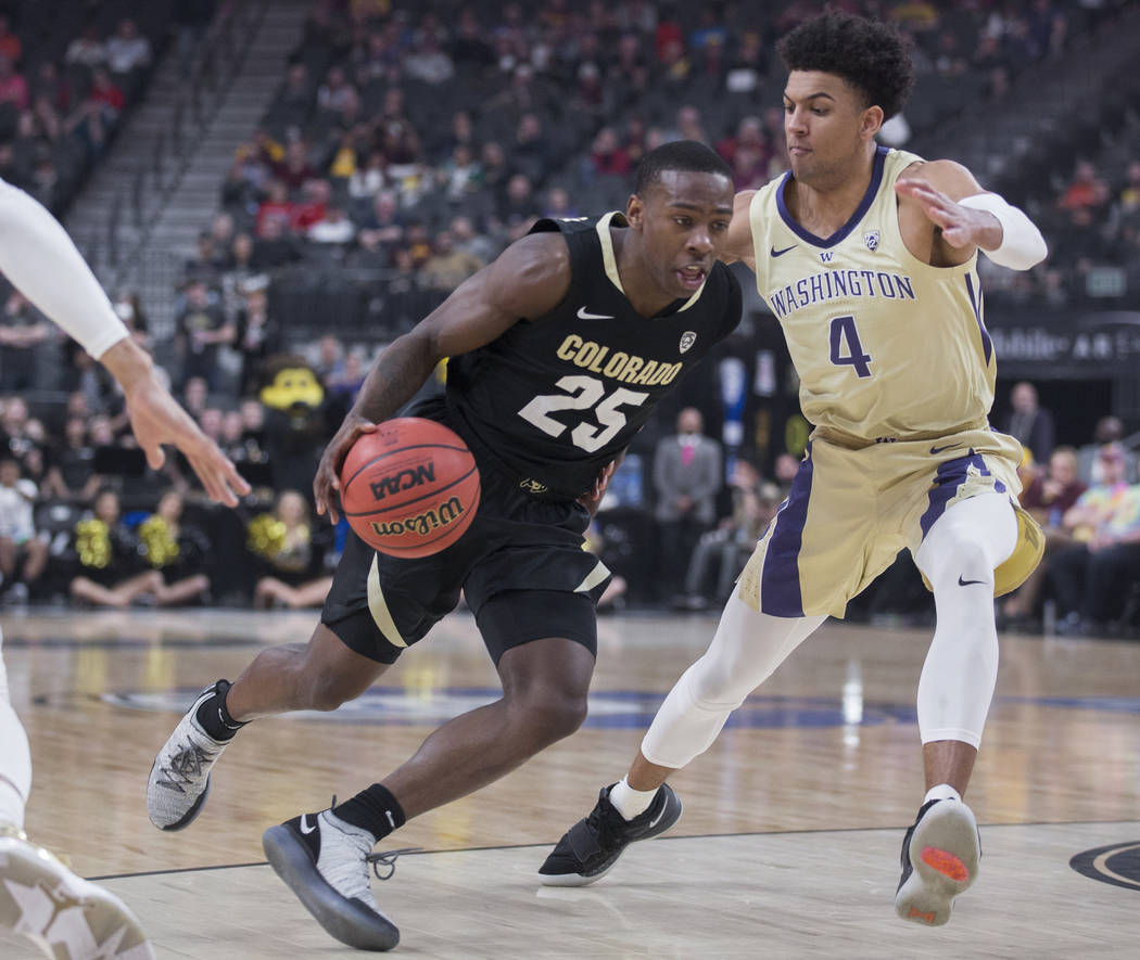 Colorado sophomore guard McKinley Wright IV (25) drives past Washington senior guard Matisse Thybulle (4) in the first half during the semifinal game of the Pac-12 tournament on Friday, March 15, ...