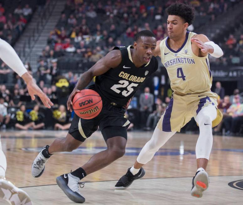 Colorado sophomore guard McKinley Wright IV (25) drives past Washington senior guard Matisse Thybulle (4) in the first half during the semifinal game of the Pac-12 tournament on Friday, March 15, ...