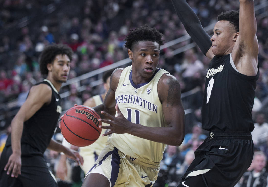 Washington sophomore forward Nahziah Carter (11) drives past Colorado junior guard Shane Gatling (0) in the second half during the semifinal game of the Pac-12 tournament on Friday, March 15, 2019 ...