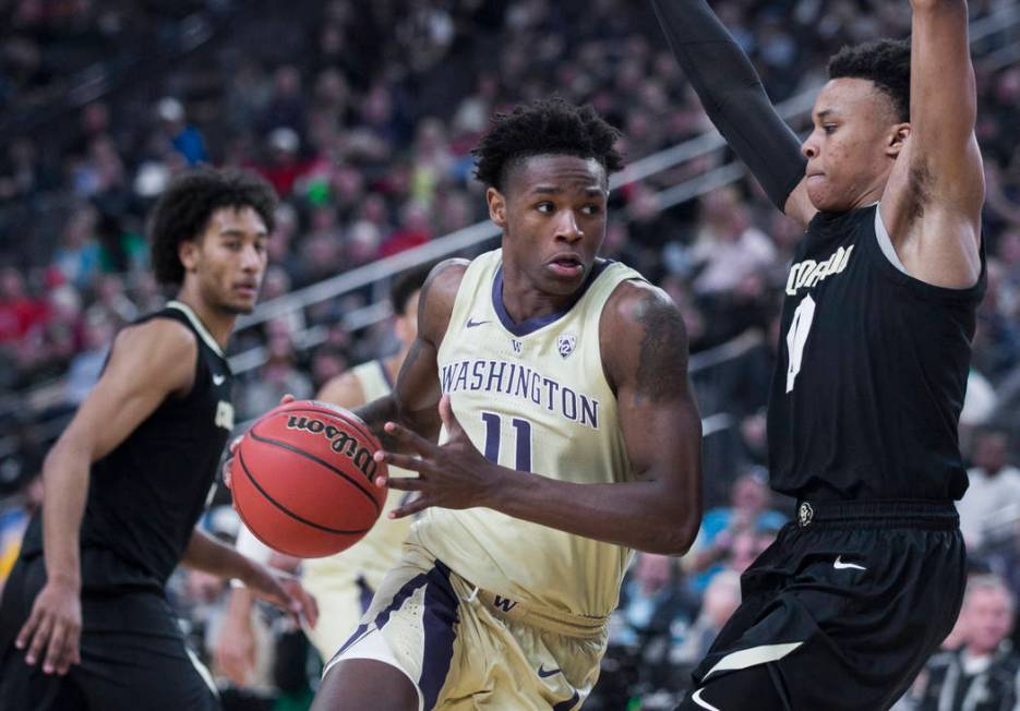 Washington sophomore forward Nahziah Carter (11) drives past Colorado junior guard Shane Gatling (0) in the second half during the semifinal game of the Pac-12 tournament on Friday, March 15, 2019 ...