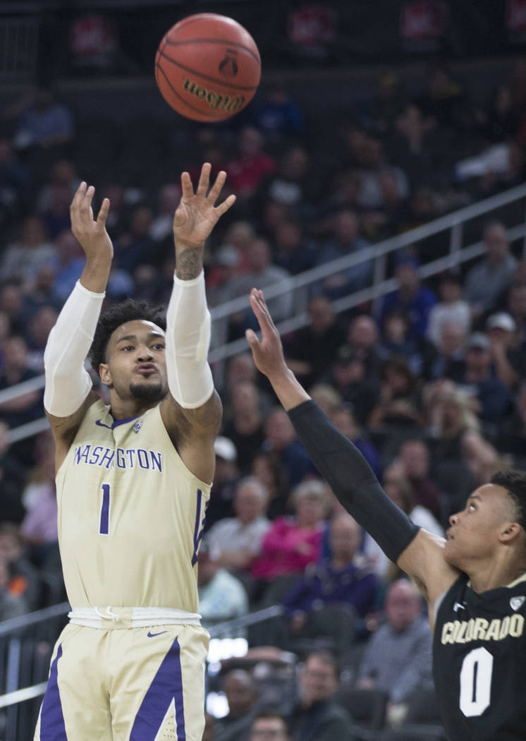 Washington senior guard David Crisp (1) shoots a corner three over Colorado junior guard Shane Gatling (0) in the second half during the semifinal game of the Pac-12 tournament on Friday, March 15 ...
