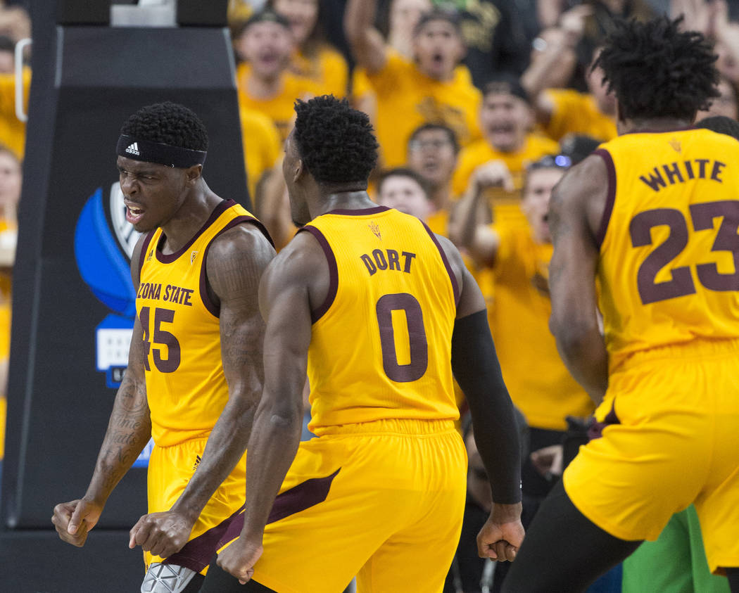 Arizona State senior forward Zylan Cheatham (45) celebrates with teammate Luguentz Dort (0) and Romello White (23) after getting fouled while scoring in the second half during their semifinal game ...
