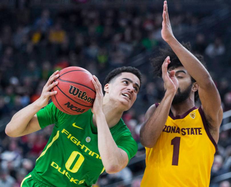Oregon freshman guard Will Richardson (0) drives past Arizona State sophomore guard Remy Martin (1) in the second half during the semifinal game of the Pac-12 tournament on Friday, March 15, 2019 ...