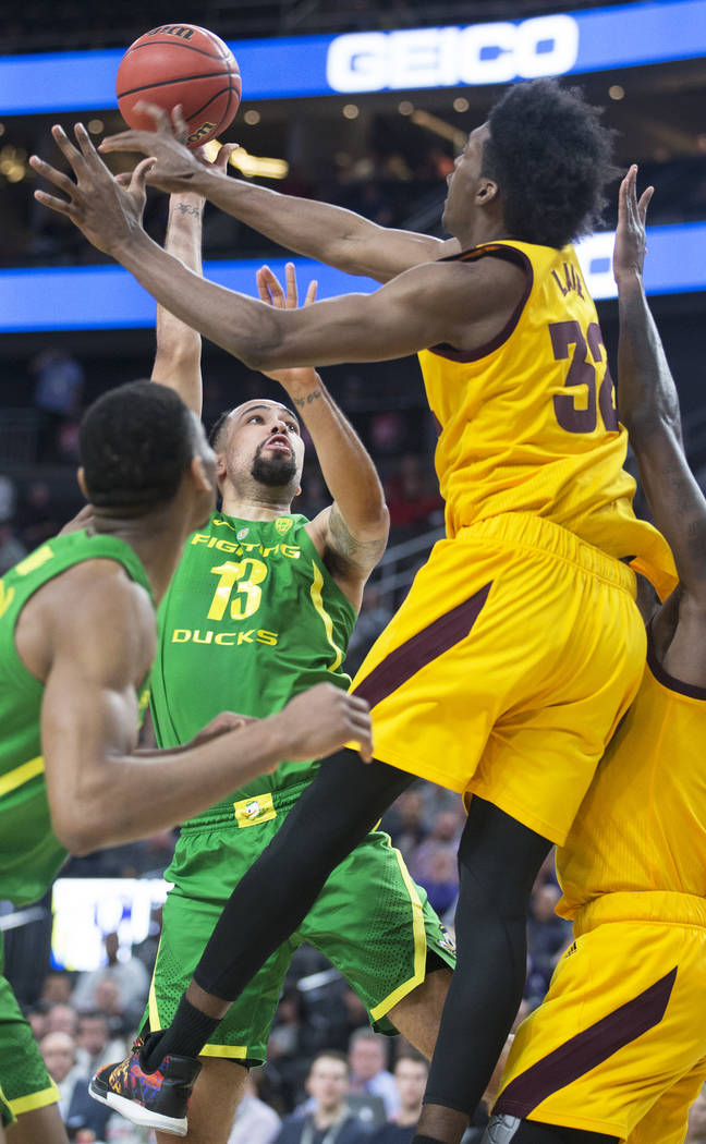 Oregon senior forward Paul White (13) shoots a jump shot over Arizona State senior forward De'Quon Lake (32) in the second half during the semifinal game of the Pac-12 tournament on Friday, March ...