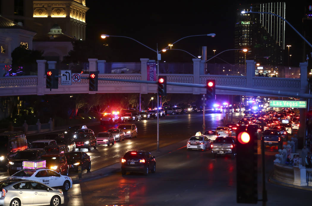 Las Vegas police officers investigate outside of the north valet at the Bellagio after police fired at a robbery suspect in Las Vegas on Friday, March 15, 2019. (Chase Stevens/Las Vegas Review-Jou ...