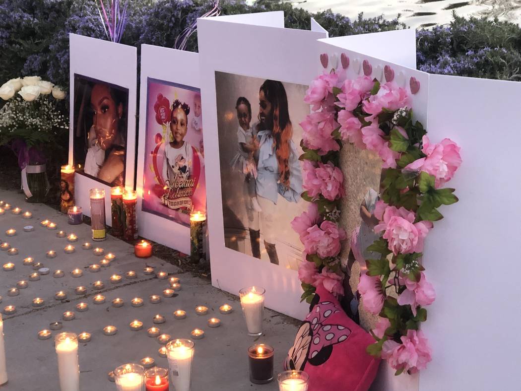 Candles illuminated pictures during a vigil on Saturday, March 16, 2019, in North Las Vegas for Sierra Robinson, 24, and her daughter, 2-year-old Noelani Robinson. Police said Sierra Robinson, of ...